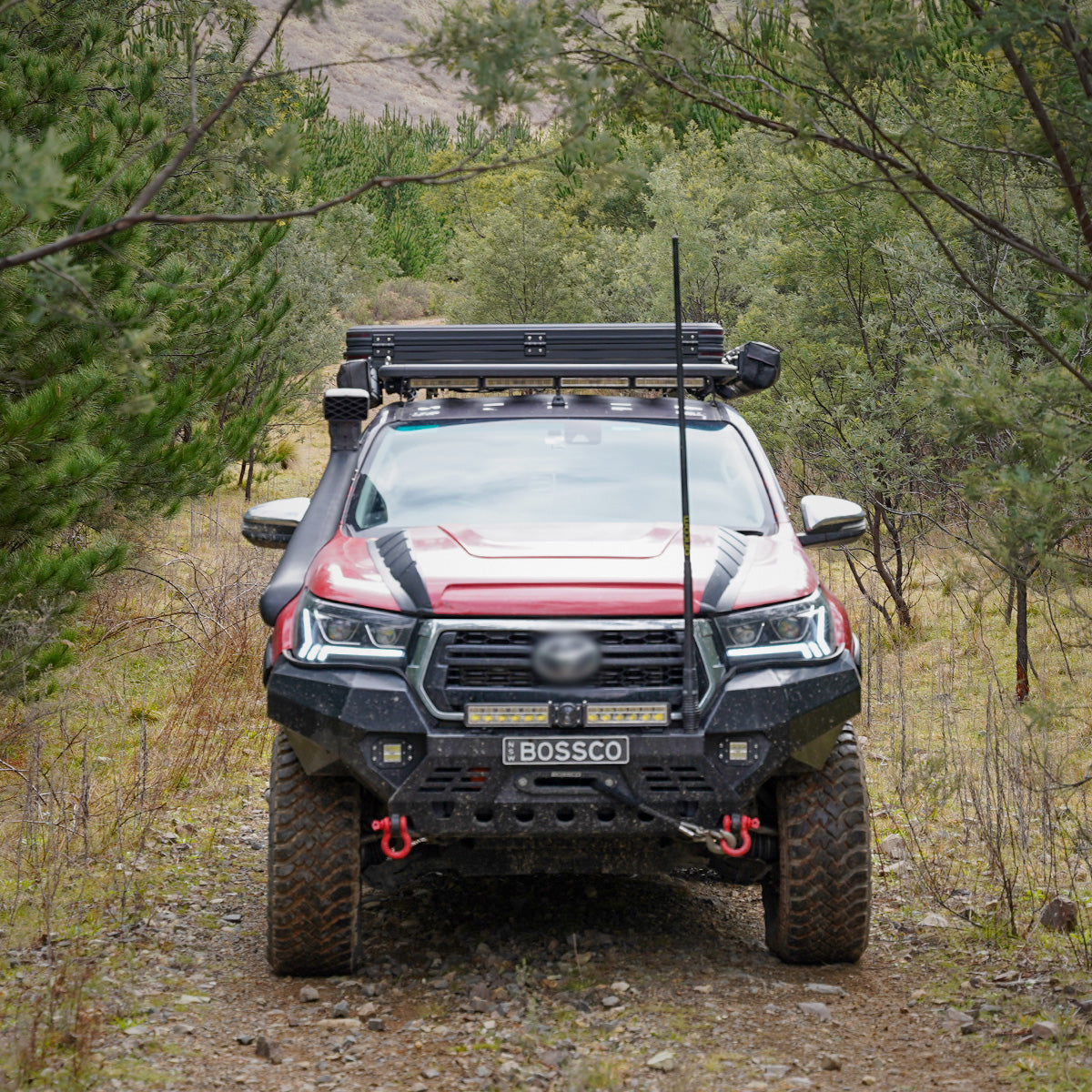 Black Bull Bar installed on a red Ute by Bossco 4x4 Accessories and a bull bar antenna. Platform roof rack basket on a pick up truck roof