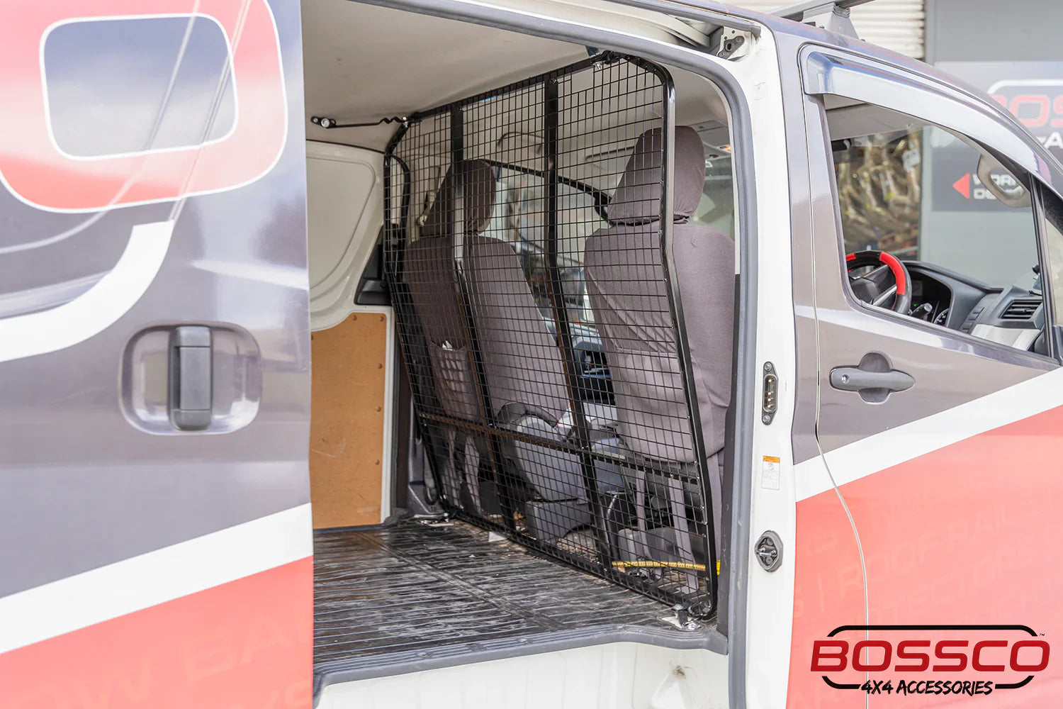 Cargo Barrier installed by Bossco 4x4 Accessories in a red transport van branded by Bossco Auto