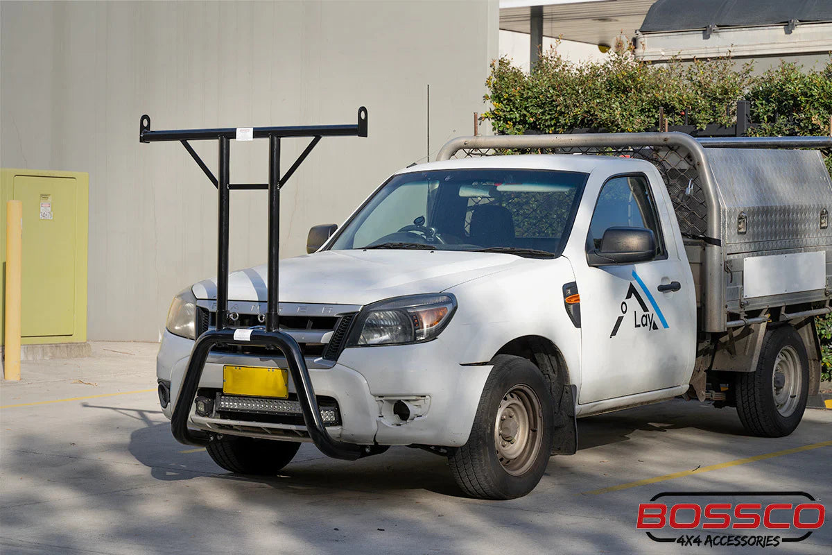 A Ladder rack and a Nudge Bar Ladder Rack in stalled by Bossco 4x4 Accessories on a white Ute parked at Bossco 4x4 car park