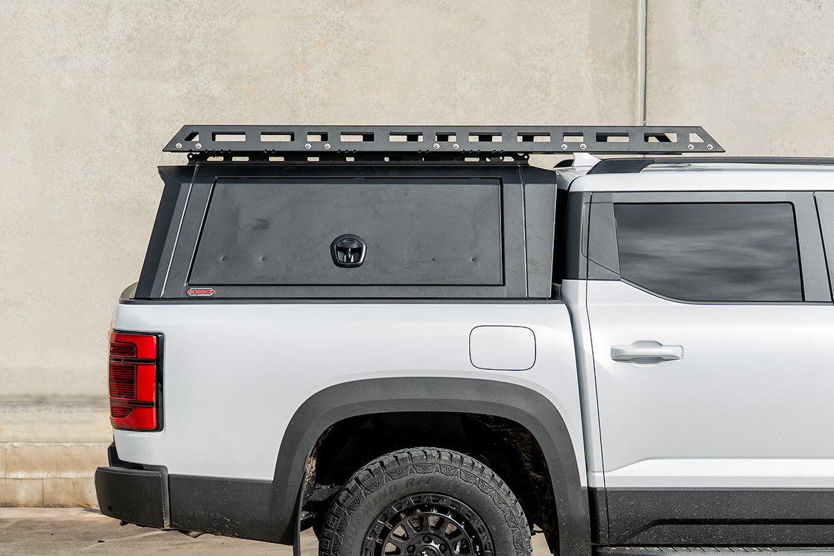Cantilever platform rack extending over the cab from a Bossco canopy on a white ute