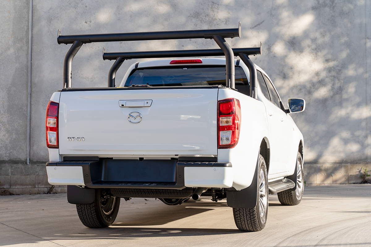 White ute with ladder rack supports fitted above its roller cover